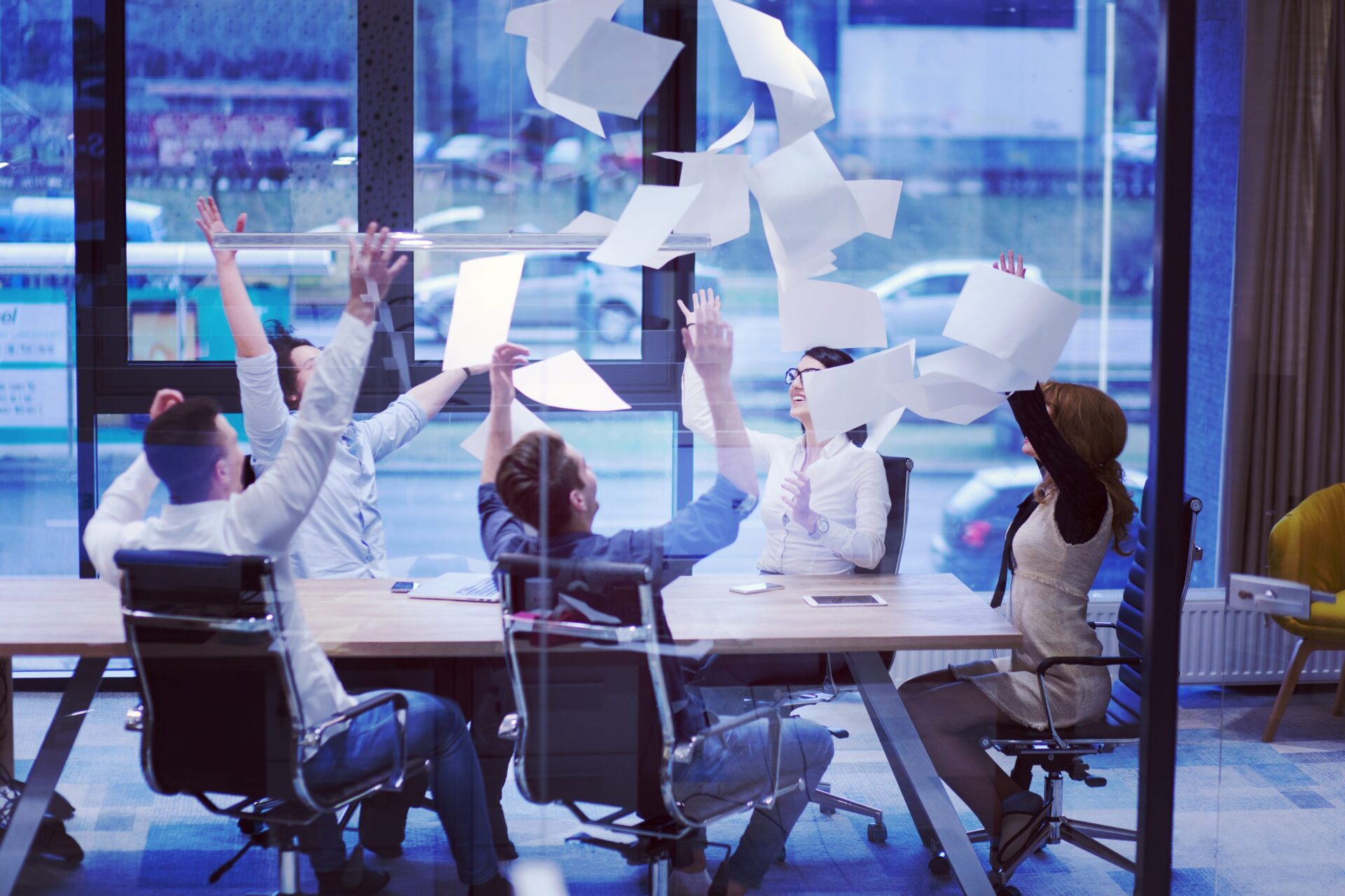 Happy team throwing papers in air